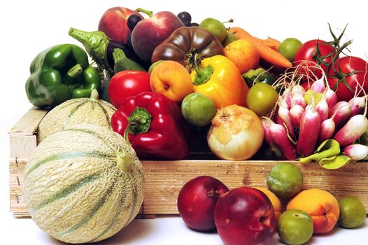 crates of fruit and vegetables on white background in studio.