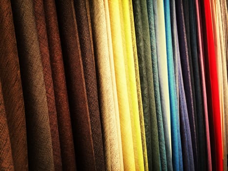 Selection of colorful fabrics in a textile store.