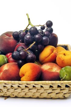 Basket of fruit isolated on white background in studio