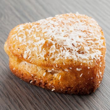 Heart biscuit over wooden table, square image