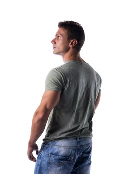 Handsome muscular fit young man isolated on white background looking to a side, back view