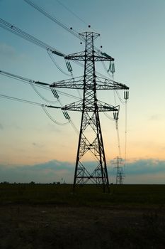 Many electric towers against dusk sky