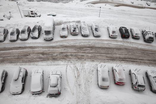 Parking cars covered by a lot of snow