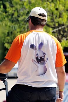 A man back with a T-shirt with an idiot rabbit in the back