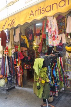 clothing store in Anduze pedestrian street, where tourists love to walk around and buy souvenirs from vacation.