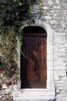 Front door of an old wooden house in the village of Vezenobres in the French department of Gard