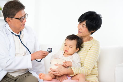 Family doctor examining baby girl. Pediatrician and patient.