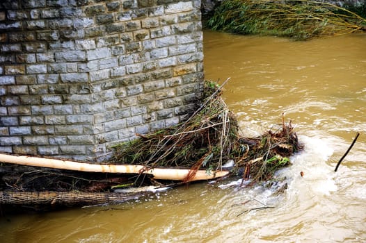 Saint-Hippolyte-du-Fort, a small French town in the foothills of the Cevennes Gard along the river Vidourle The swollen after heavy rains trees have blocked the bridge pier.