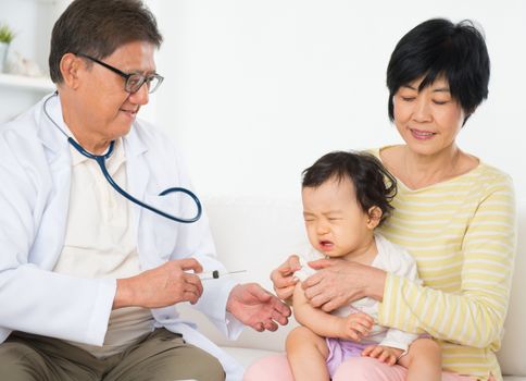 Family doctor vaccines  or injection to baby girl. Pediatrician and patient.