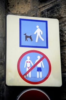 Prohibition sign to enter the city in a swimsuit and a dog