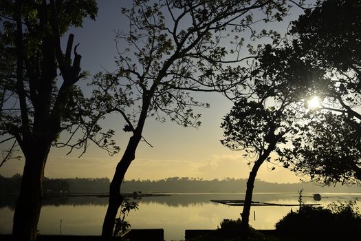 Fiery Sunrise over lake of a fishing and farming village in the Philippines.