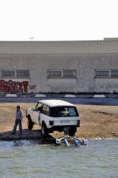 In anticipation of the return of a boat on the Canal du Rhone in Aigues-Mortes in the heart of the Camargue in the south-east of France.