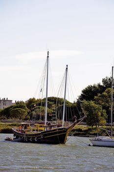 Old boat on the Canal du Rhone in Aigues-Mortes in the heart of the Camargue in the south-east of France.