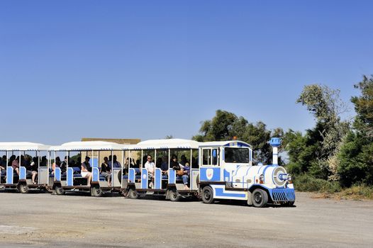 tourists in the tourist train to visit the salt business of Aigues-Mortes and to tour the mine salt site.