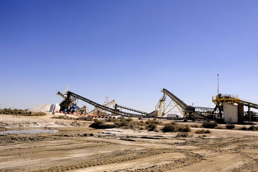 Site operating company saline Aigues-Mortes in the Camargue where stackers stack hills of sea salt.