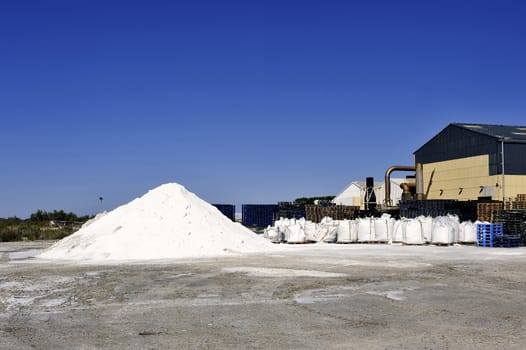 Site operating company saline Aigues-Mortes in the Camargue where stackers stack hills of sea salt.