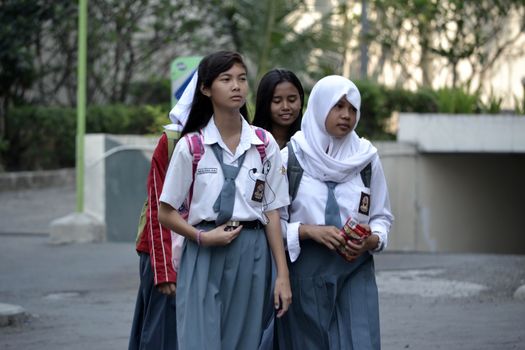 Bandung, Indonesia - September 17, 2014: Senior High School student get walking together to their home.