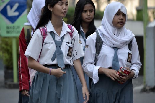 Bandung, Indonesia - September 17, 2014: Senior High School student get walking together to their home.