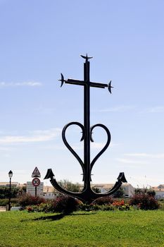 Camarguaise cross the center of a roundabout in the French town of Saintes-Maries-de-la-Mer.
