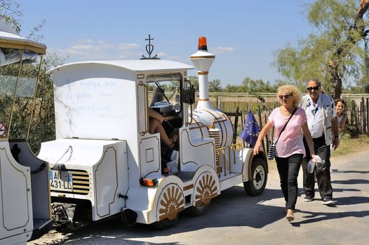 Tourists leave after their visit to the Camargue horses and the little train back to resume their walk.