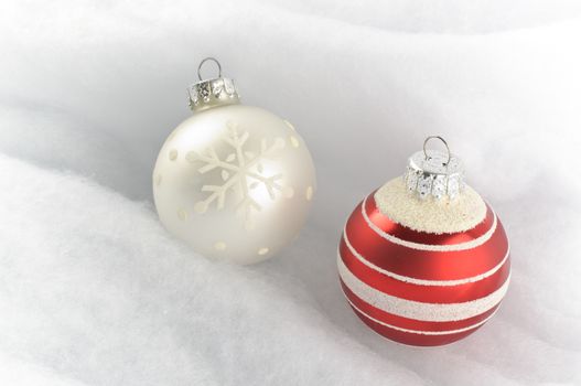 Christmas Baubles on snow white background