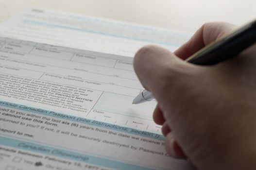 Close up hand prepare to signature of Canadian passport application