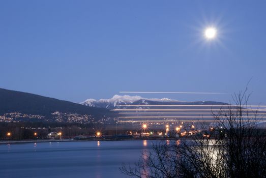 Night scene of downtown Vancouver with boat pass by lighting