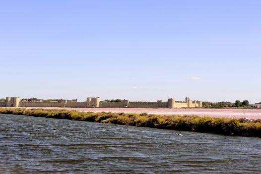 The ramparts of the walled city of Aigues-Mortes seen pink salt