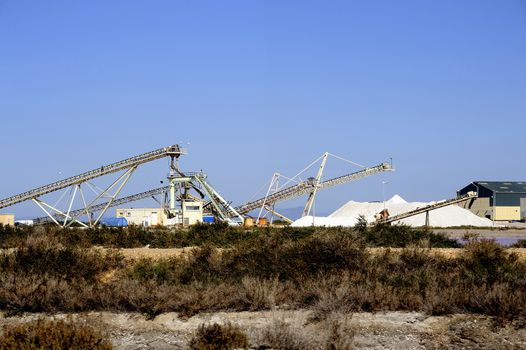 Site operating company saline Aigues-Mortes in the Camargue where stackers stack hills of sea salt.