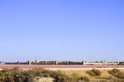 The ramparts of the walled city of Aigues-Mortes seen pink salt