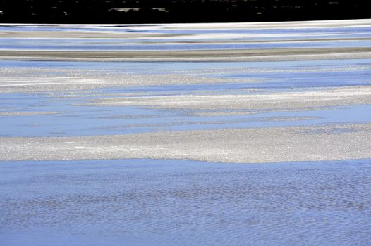 Salt marshes of Camargue in Aigues-Mortes with salt crystals visible on the surface.
