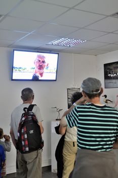 Tourists watching a video saline Aigues-Mortes on the history of the company and the company work.
