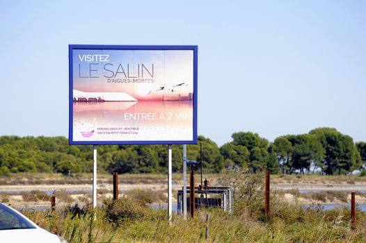 billboard saline Aigues-Mortes in Camargue to announce that tourists can visit the industrial enterprise.