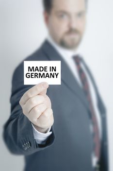 A business man holding a card with the message made in germany