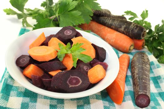 cut carrots in a white bowl against white background