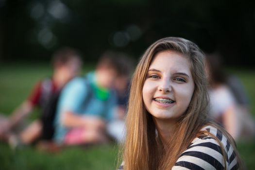 One satisfied teen female with braces on teeth