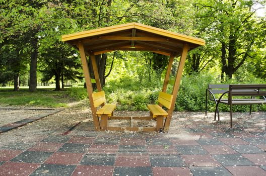 Wooden pergola painted yellow glazing built in the park