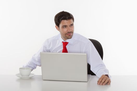 young business executive in white shirt behind desk with laptop