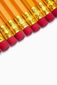 closeup of yellow pencils with red erasers isolated on white