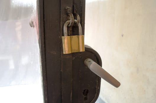 Rusty Padlock and old door handle