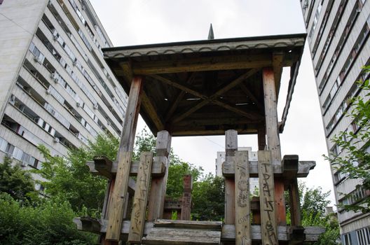 Wooden gazebo in a shady playground area of the park