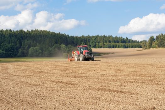 farmer on tractor plowing the field in southern bohemia