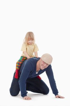 boy with long blond hair riding on fathers back - isolated on white