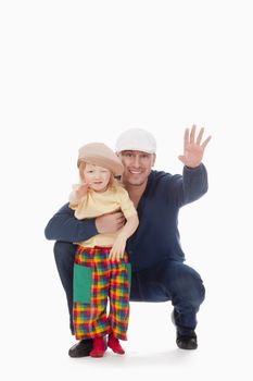 father and son with caps smiling and waving - isolated on white