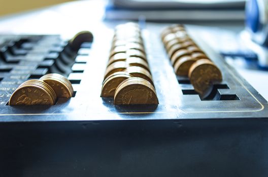 Golden coins on a black dust tray