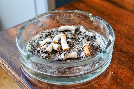 Ashtray Full of Cigarettes burnt butts wet and disgusting