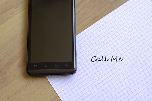 Phone and white sheet notepad on the desk