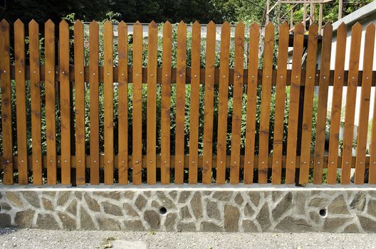 fence of wooden slats on the stones.