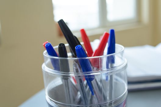 Many multicolor felt pens on wooden desk