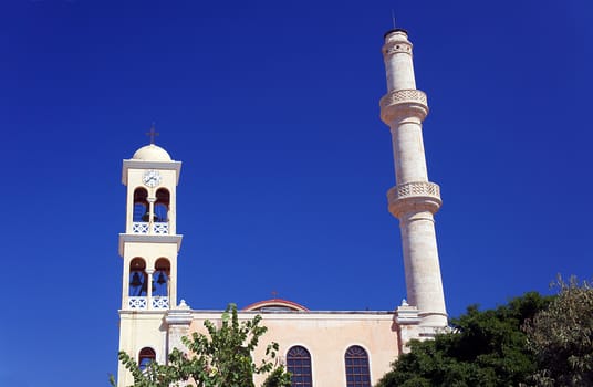 Orthodox church with a bell tower and minaret in the town of Chania, Crete